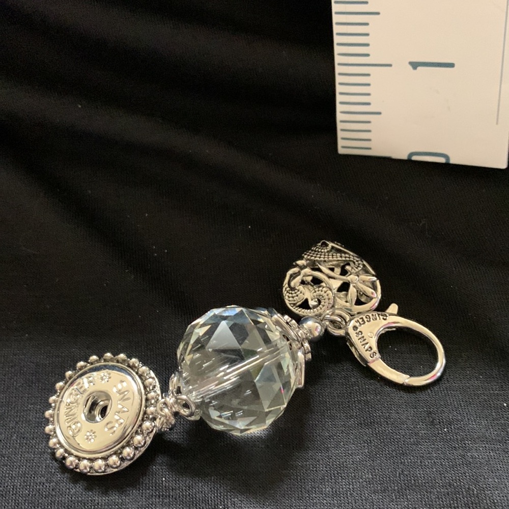 One silver tone snap key rings with dangle crystal and changeable snap.  NWOT
